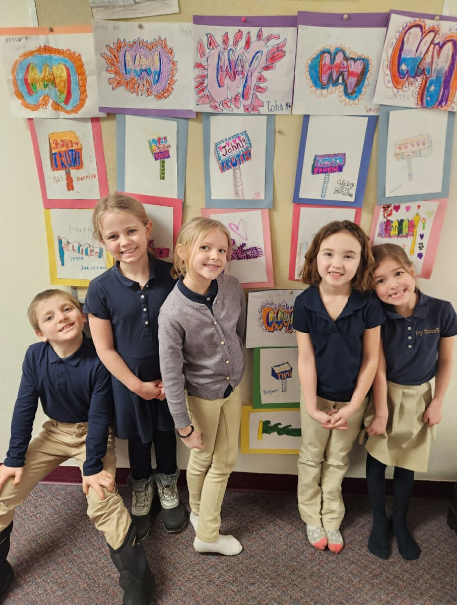 Elementary students with their artwork