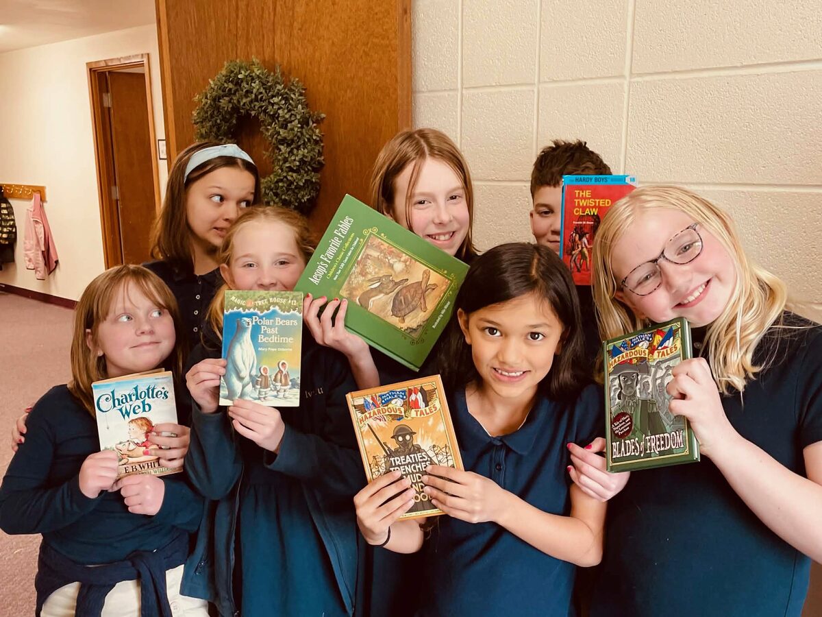 Students holding their living books