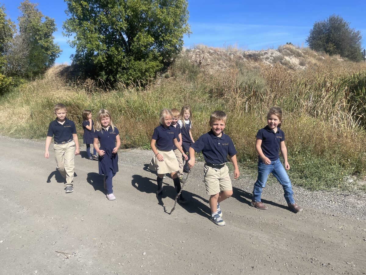 Students on a nature walk along a dirt path