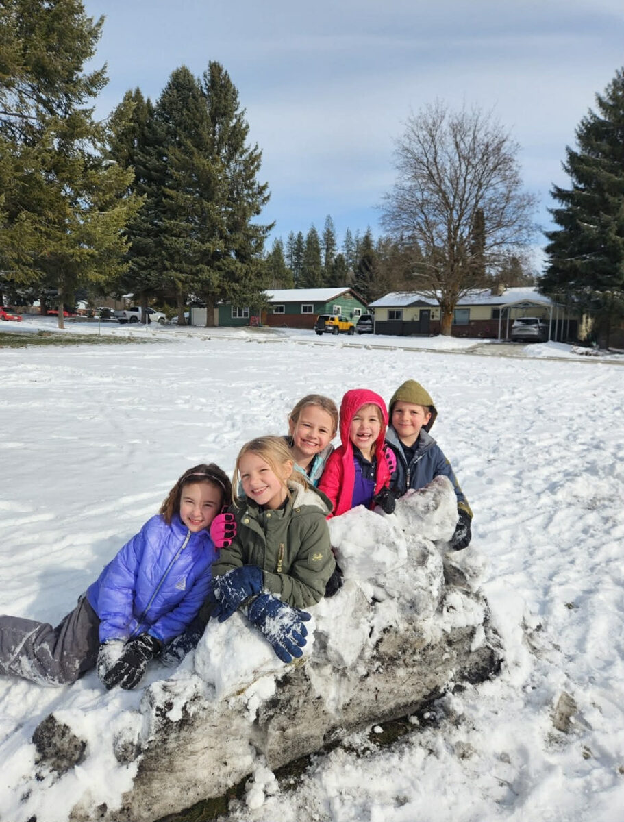 Students playing together in the snow