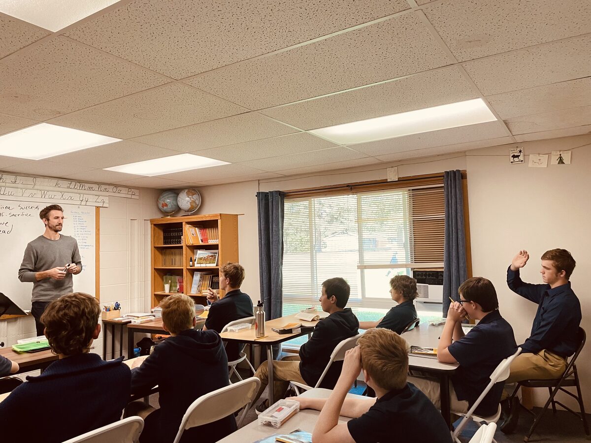 Teacher leading a classroom lesson with engaged students